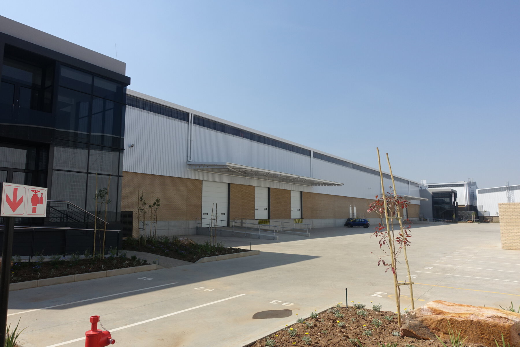 Large modern warehouse with sleek design and ample parking in Airport Park, ideal for logistics and distribution operations.