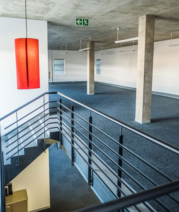 Modern Meadowview Industrial Premises Interior Spacious industrial premises in Meadowview with open-plan layout, concrete pillars, and large windows providing natural light, ideal for warehousing and manufacturing needs.