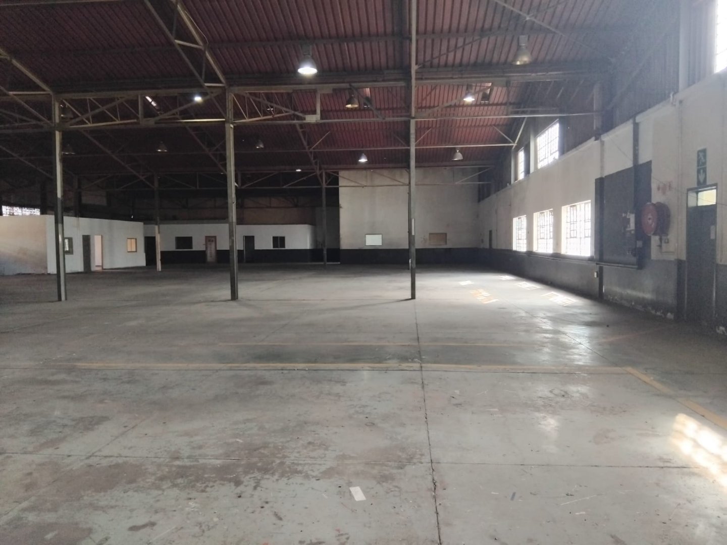Currie Group Offices & Warehouses Spacious industrial warehouse and office space with high ceilings, large windows, and ample natural light, suitable for various commercial and storage needs.