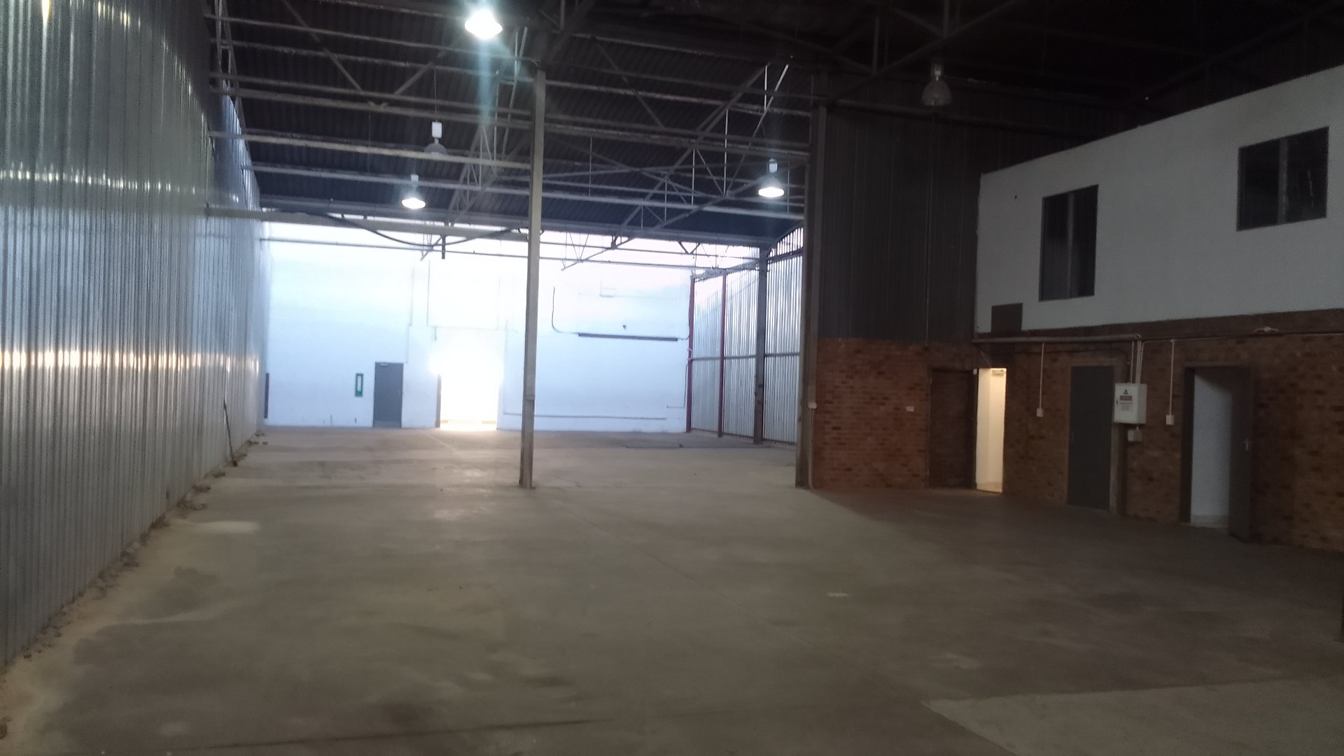 Currie Group Offices & Warehouses Interior Spacious interior of Currie Group offices and warehouses with high ceilings, open floor space, and industrial design elements.