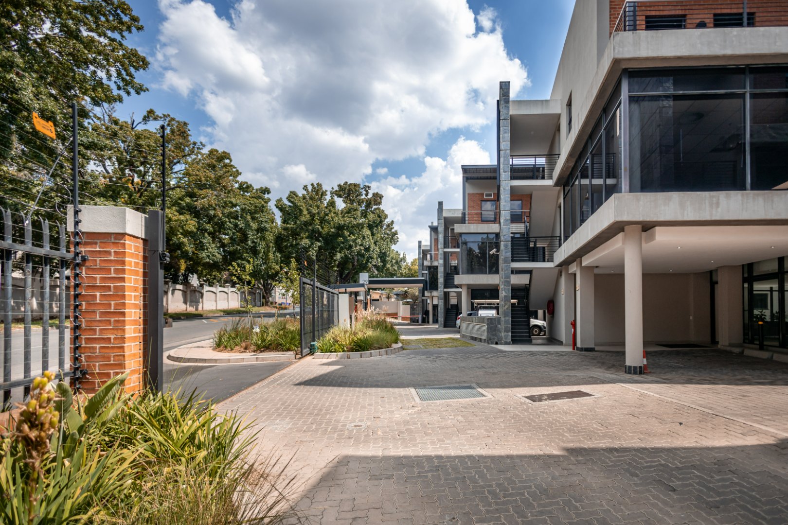 Contemporary office and warehouse buildings with clean design, large glass windows, and landscaped surroundings at Currie Group offices.