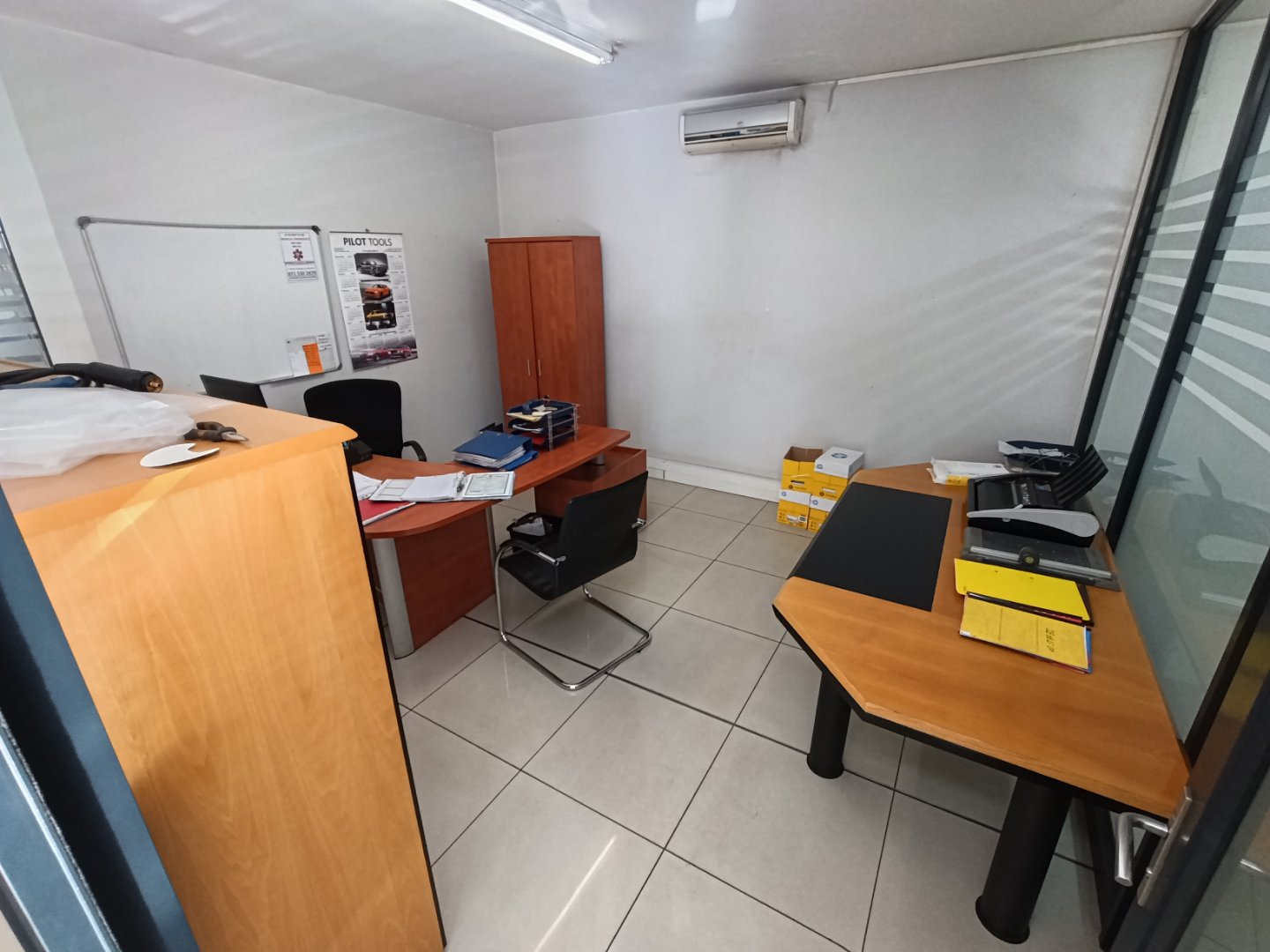 Currie Group Office & Warehouse Interior Modern office space with desks, chairs, and storage cabinets in a warehouse setting, featuring clean design and organized workspace.