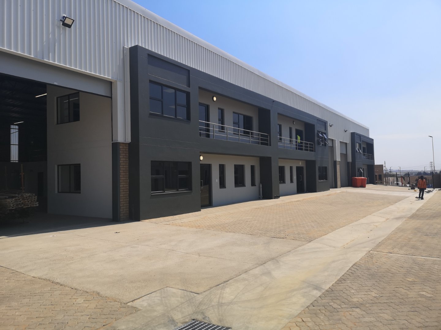 Modern office and warehouse building of Currie Group with contemporary design and large windows, located in an industrial area.