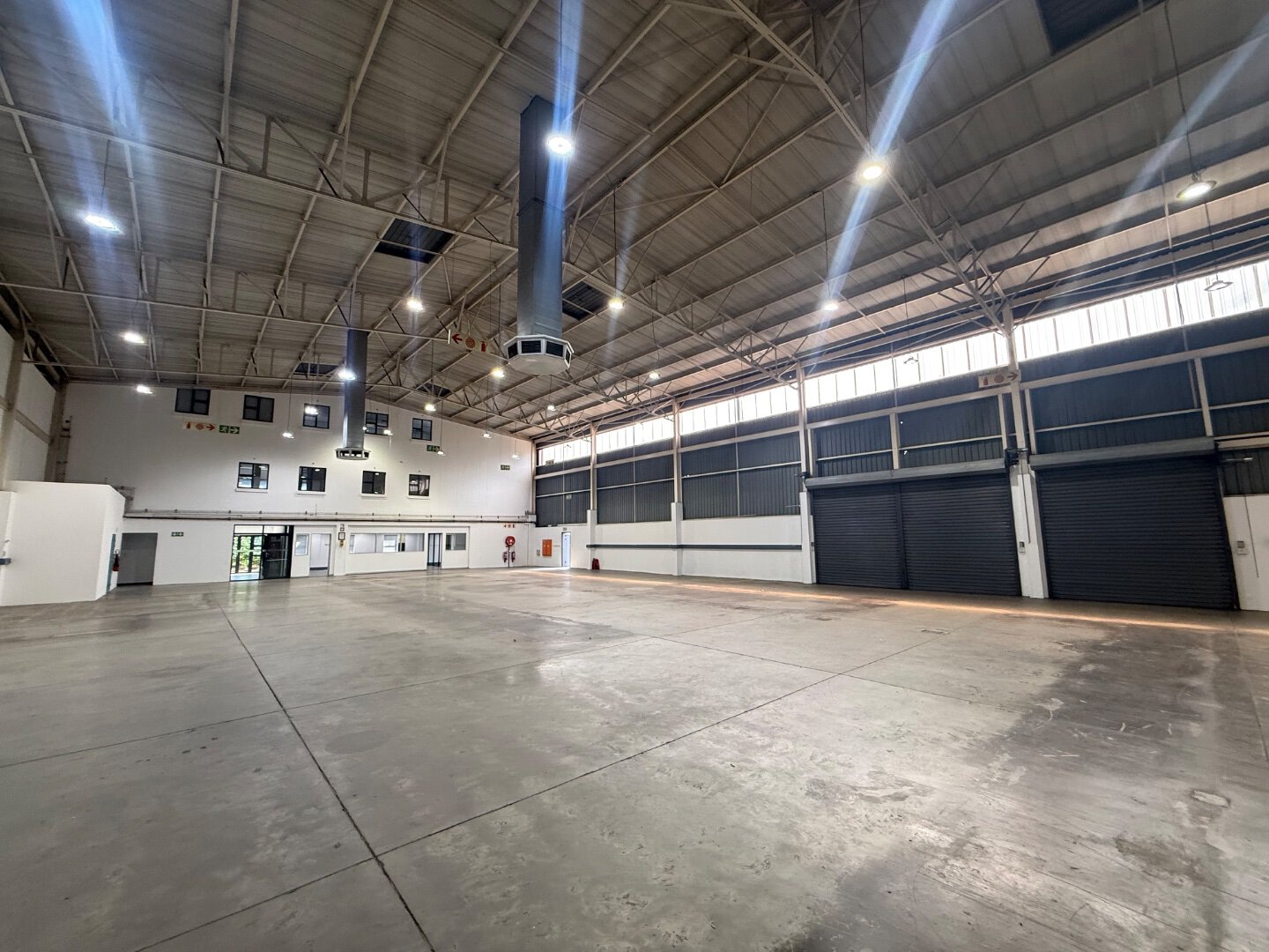 Modern Warehouse Space in Bryanston Spacious modern warehouse with high ceilings, large roller doors, and industrial lighting in Bryanston, suitable for storage and logistics.