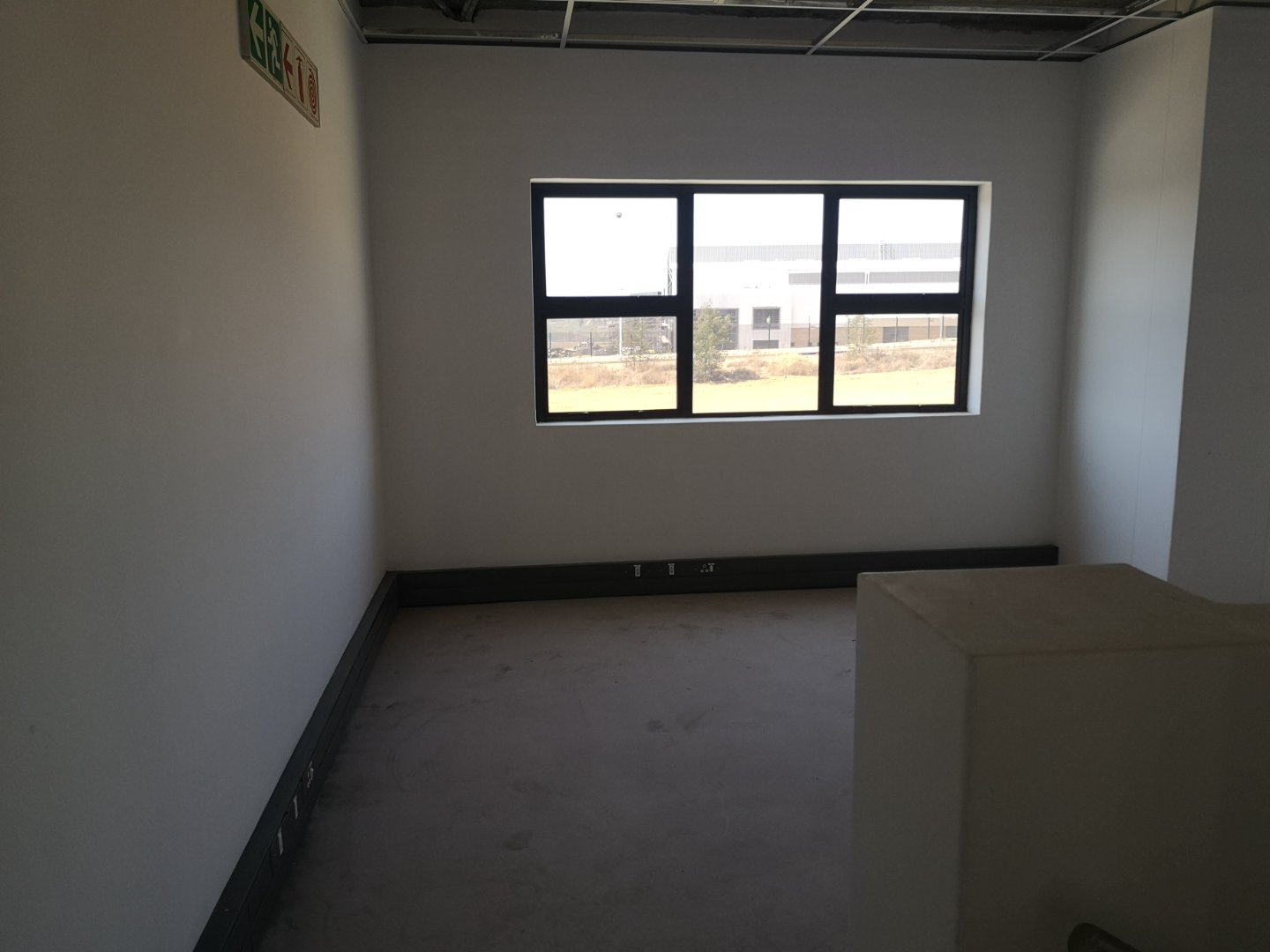 Interior of Currie Group Office Space Empty office room with large window and natural light, under construction at Currie Group offices and warehouses.