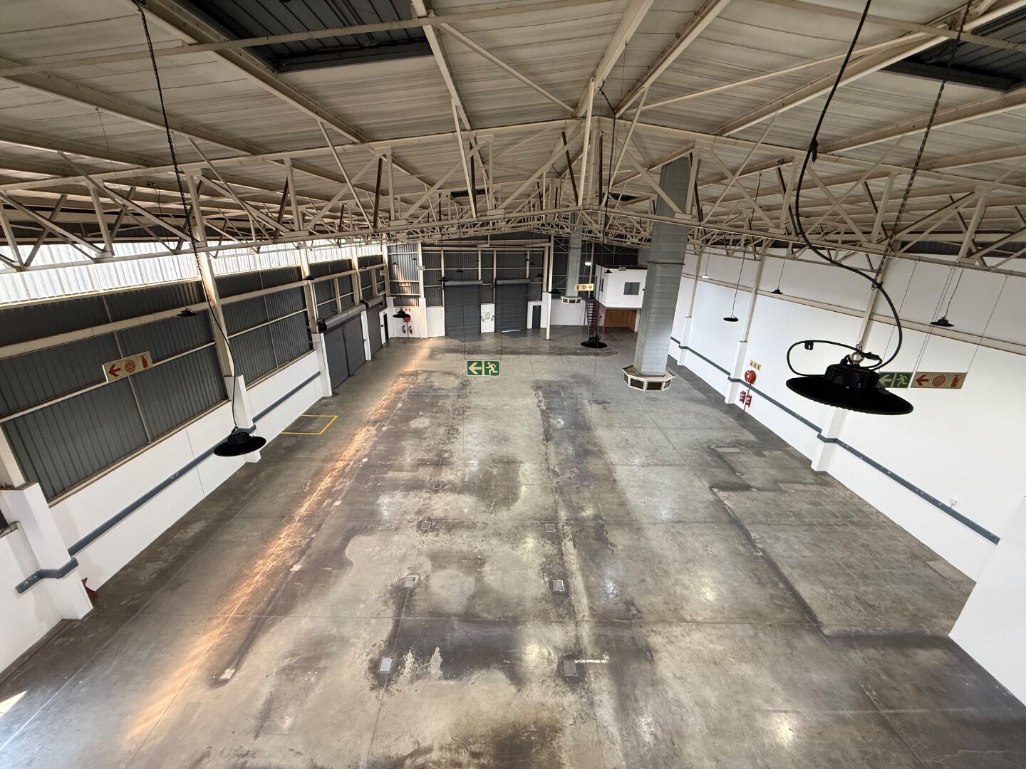 Commercial Warehouse in Bryanston Spacious commercial warehouse with high ceilings, concrete flooring, and industrial lighting, suitable for storage and logistics in Bryanston.