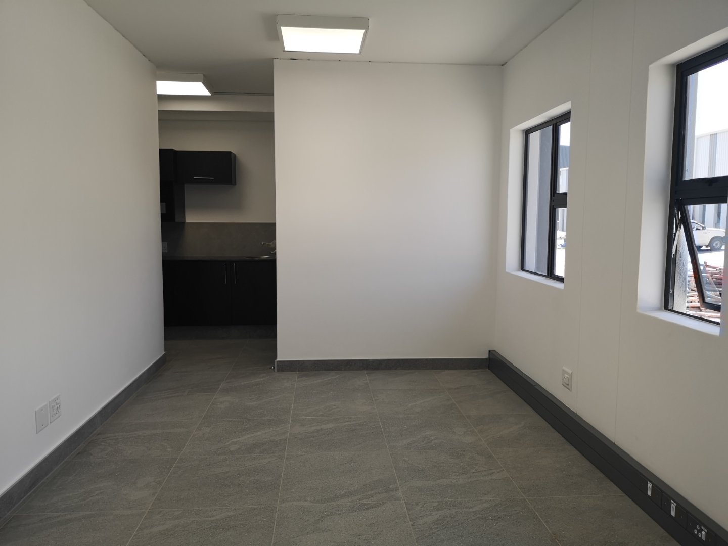 Modern Office Space Interior Bright, modern office space with large windows and neutral decor, ideal for business operations and meetings.