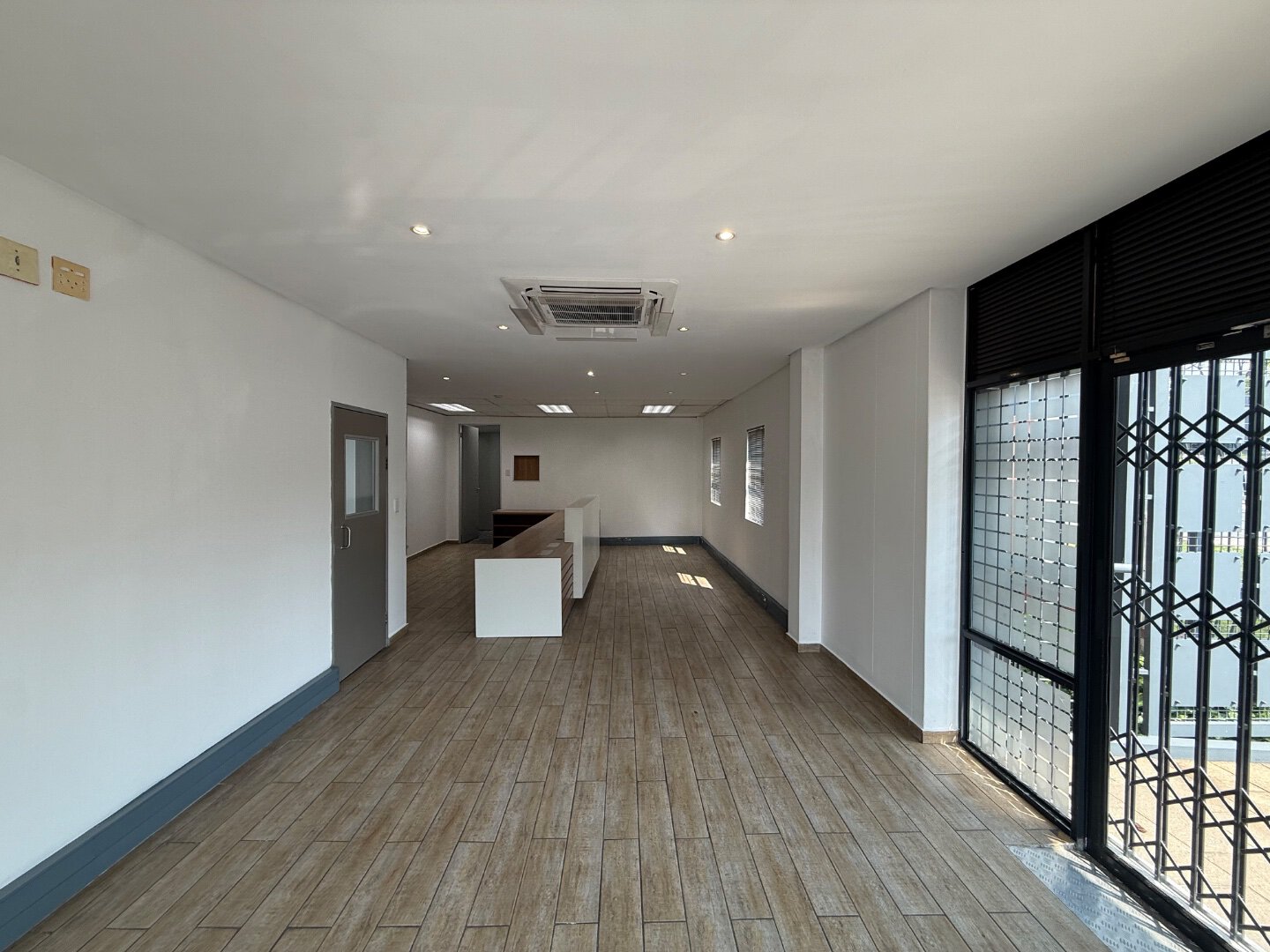 Commercial Warehouse Office Space Interior Spacious interior of a commercial warehouse office with large windows, wooden flooring, and modern lighting, located in Bryanston.