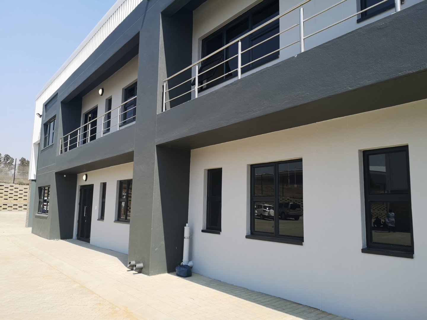 Modern Office and Warehouse Building Contemporary office and warehouse facility with modern design, large windows, and balcony railings, representing Currie Group's industrial infrastructure since 1887.