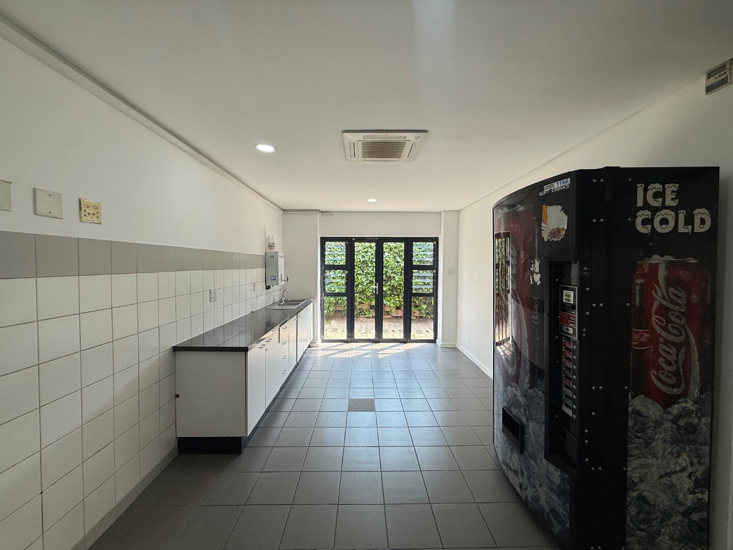 Spacious Warehouse Interior Bright, clean commercial warehouse interior with vending machine and large windows for natural light.