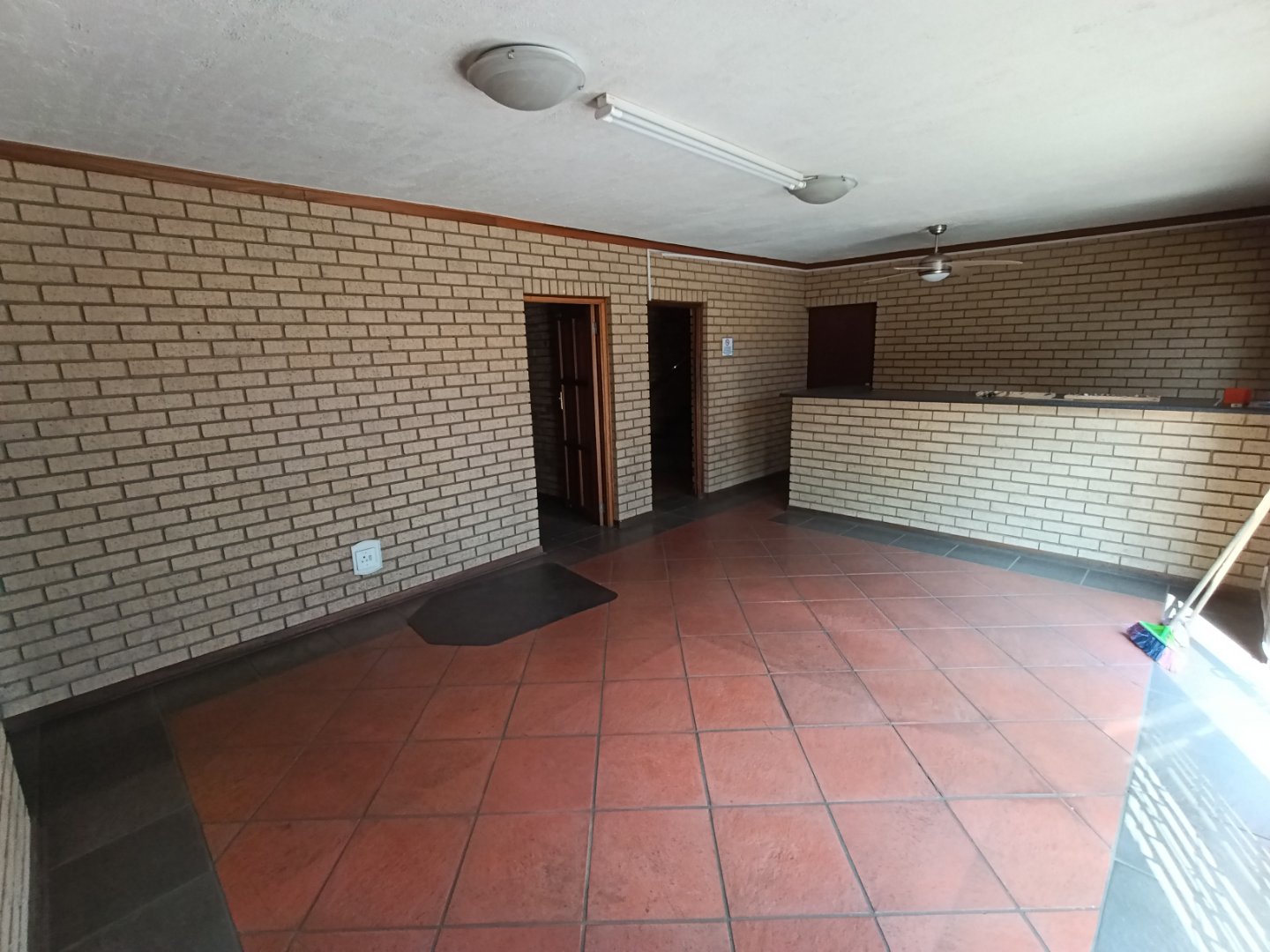 Spacious interior of Currie Group offices and warehouses with brick walls and tiled flooring, showcasing a professional industrial environment.