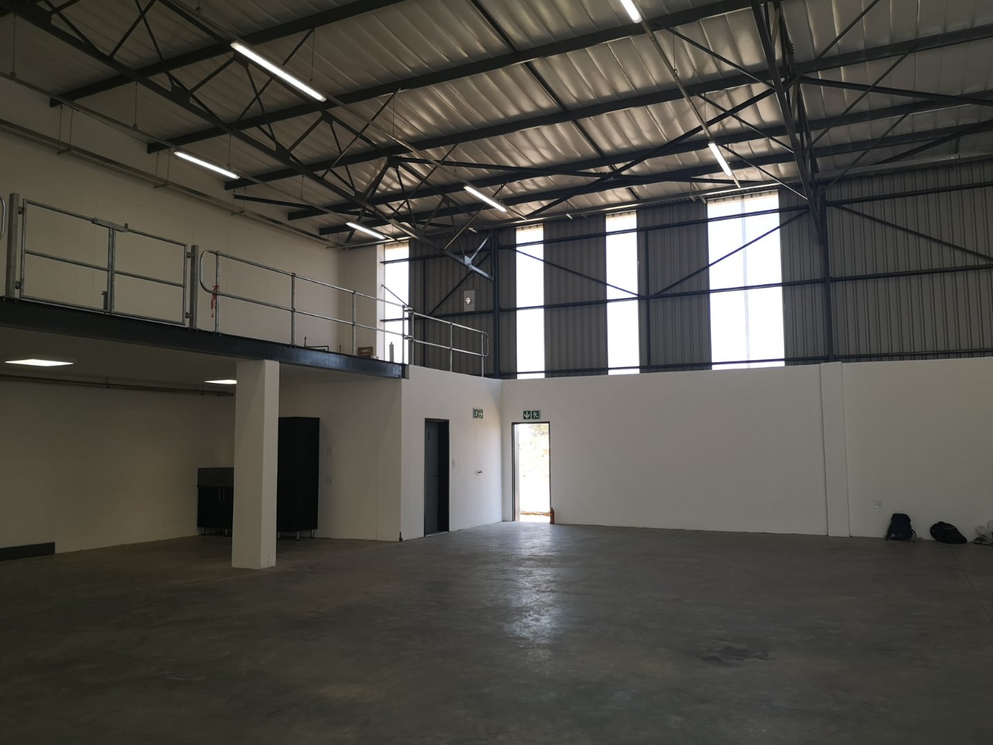Currie Group Offices and Warehouses Spacious industrial warehouse with high ceilings, metal roof, and large windows for natural light, showcasing Currie Group's modern facilities since 1887.