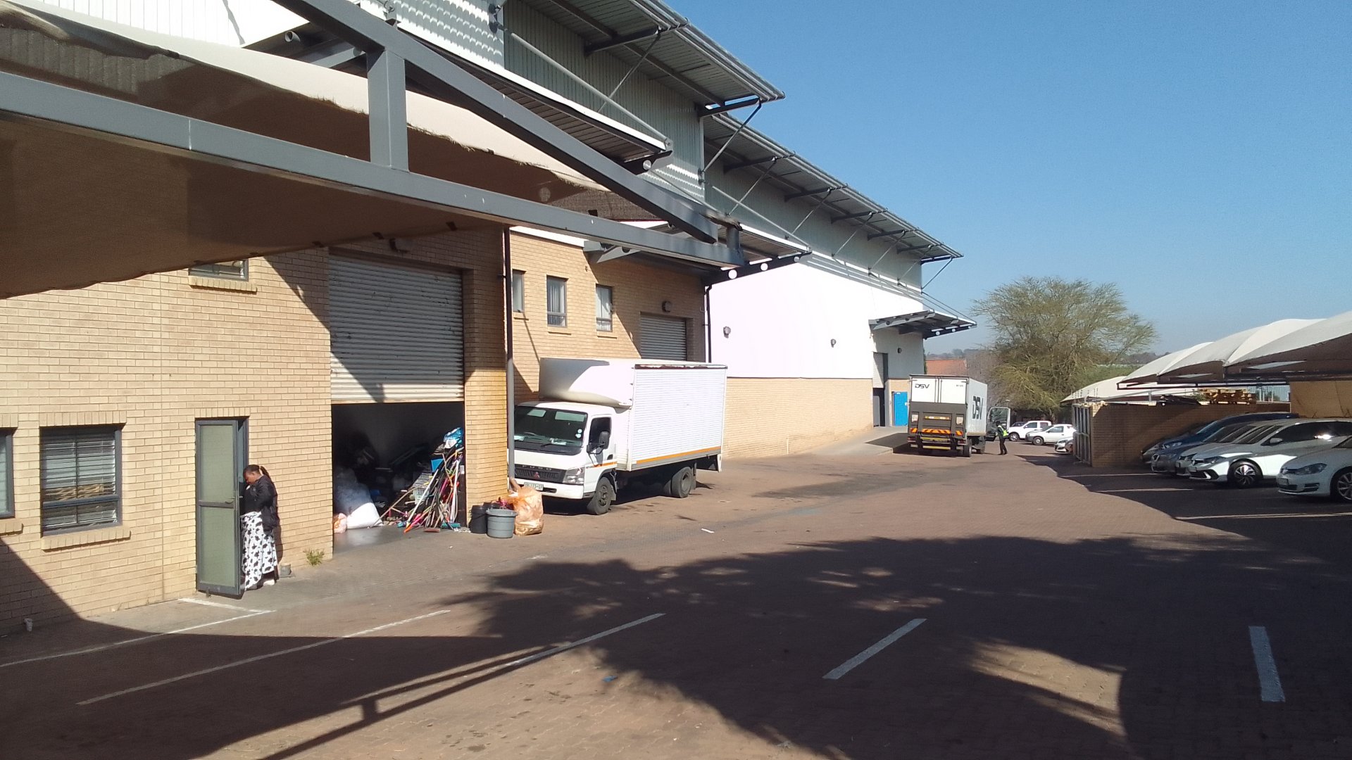 Exterior view of the secure mini unit at Linbro Park with warehouses, parking, and delivery trucks in a commercial industrial area.