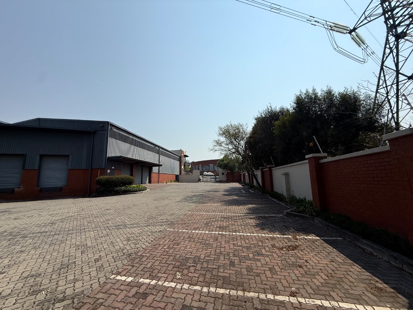 Commercial Office and Warehouse Space Spacious commercial office and warehouse area with paved parking lot and surrounding trees, located in Bryanston.