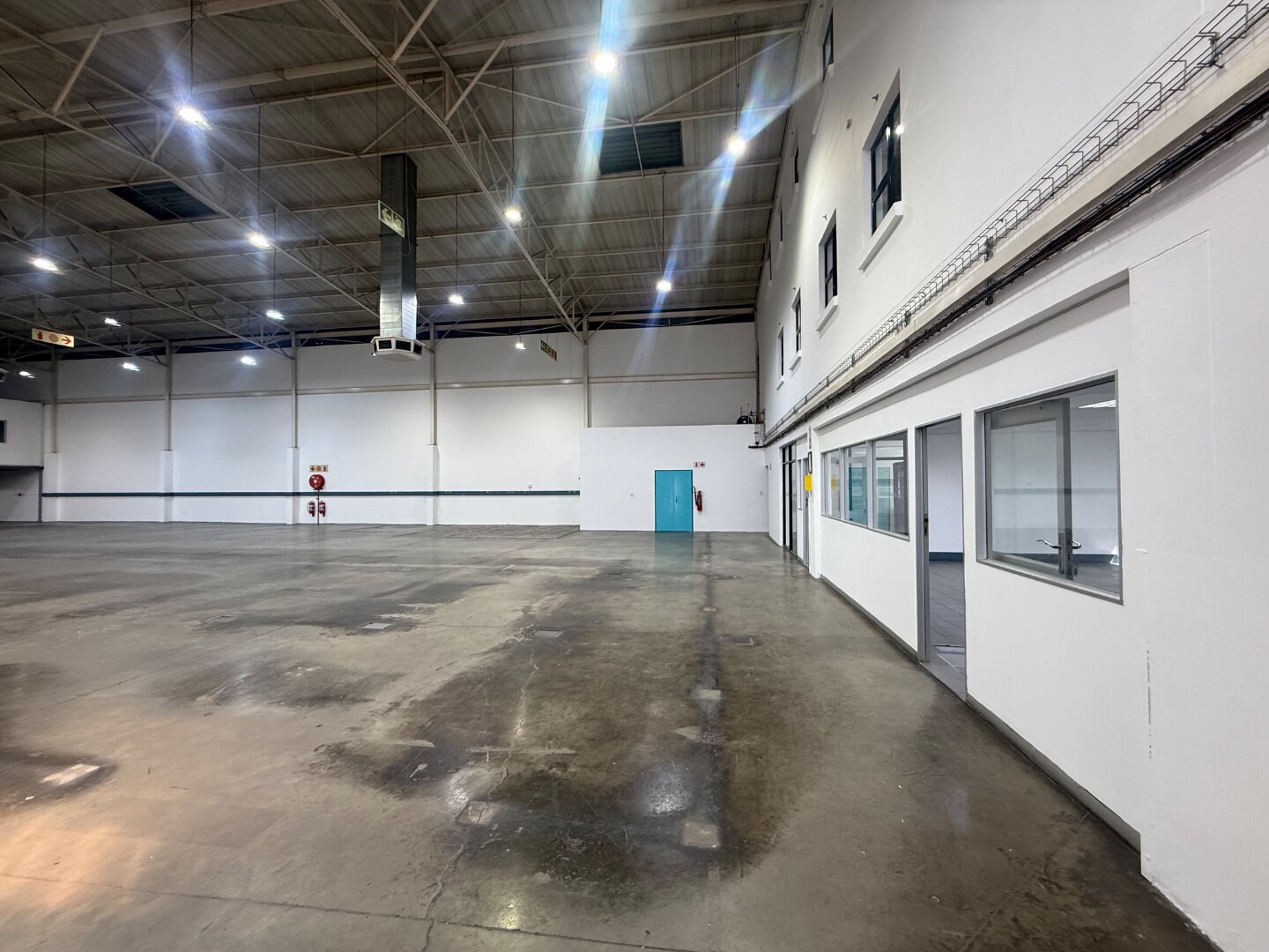 Modern Warehouse Space in Bryanston Spacious modern warehouse with high ceilings, polished concrete floors, and large windows in Bryanston, ideal for industrial or commercial use.