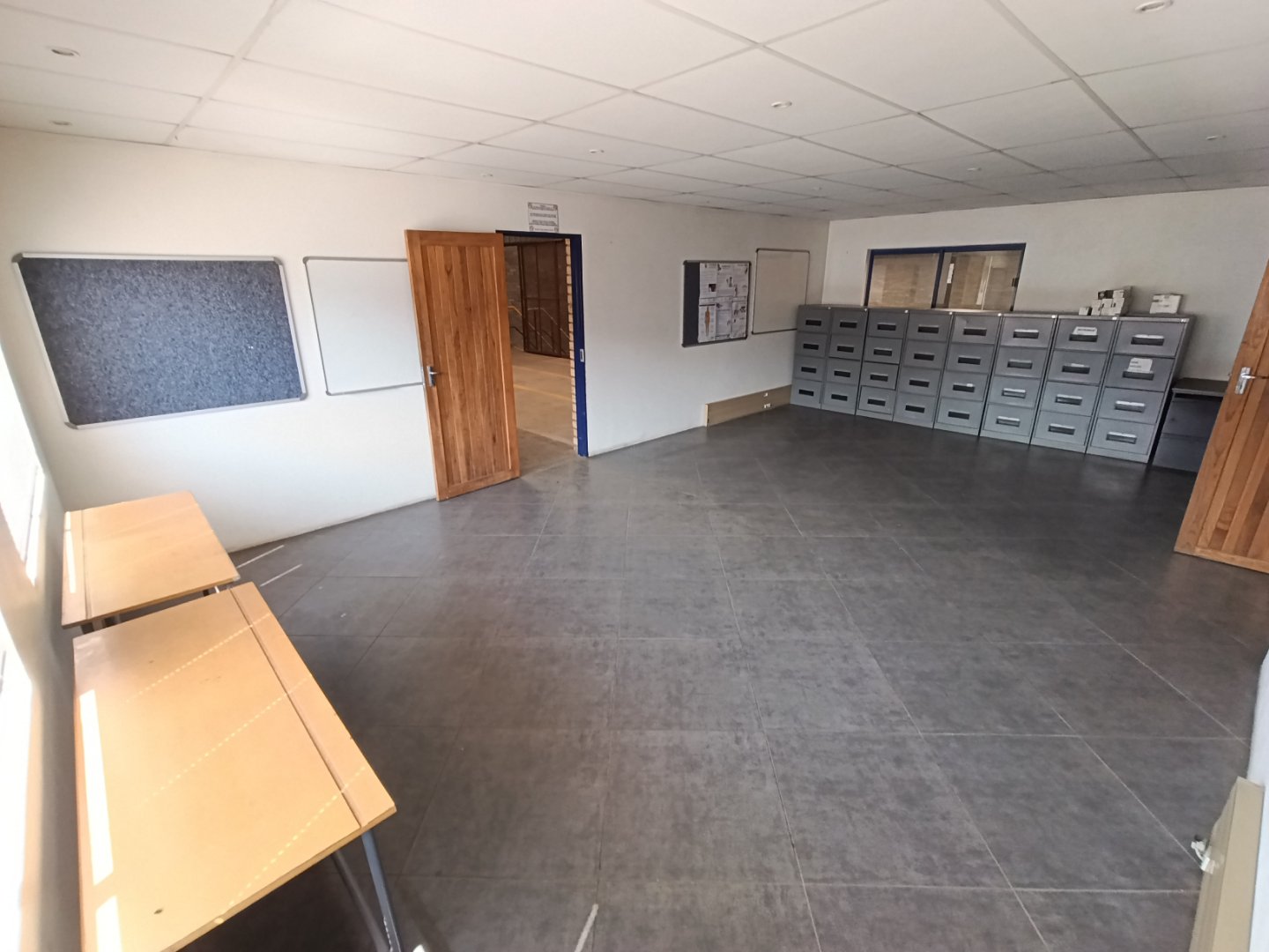 Offices & Warehouses Since 1887 Spacious office room with mailboxes and benches, part of Currie Group's office and warehouse facilities since 1887.