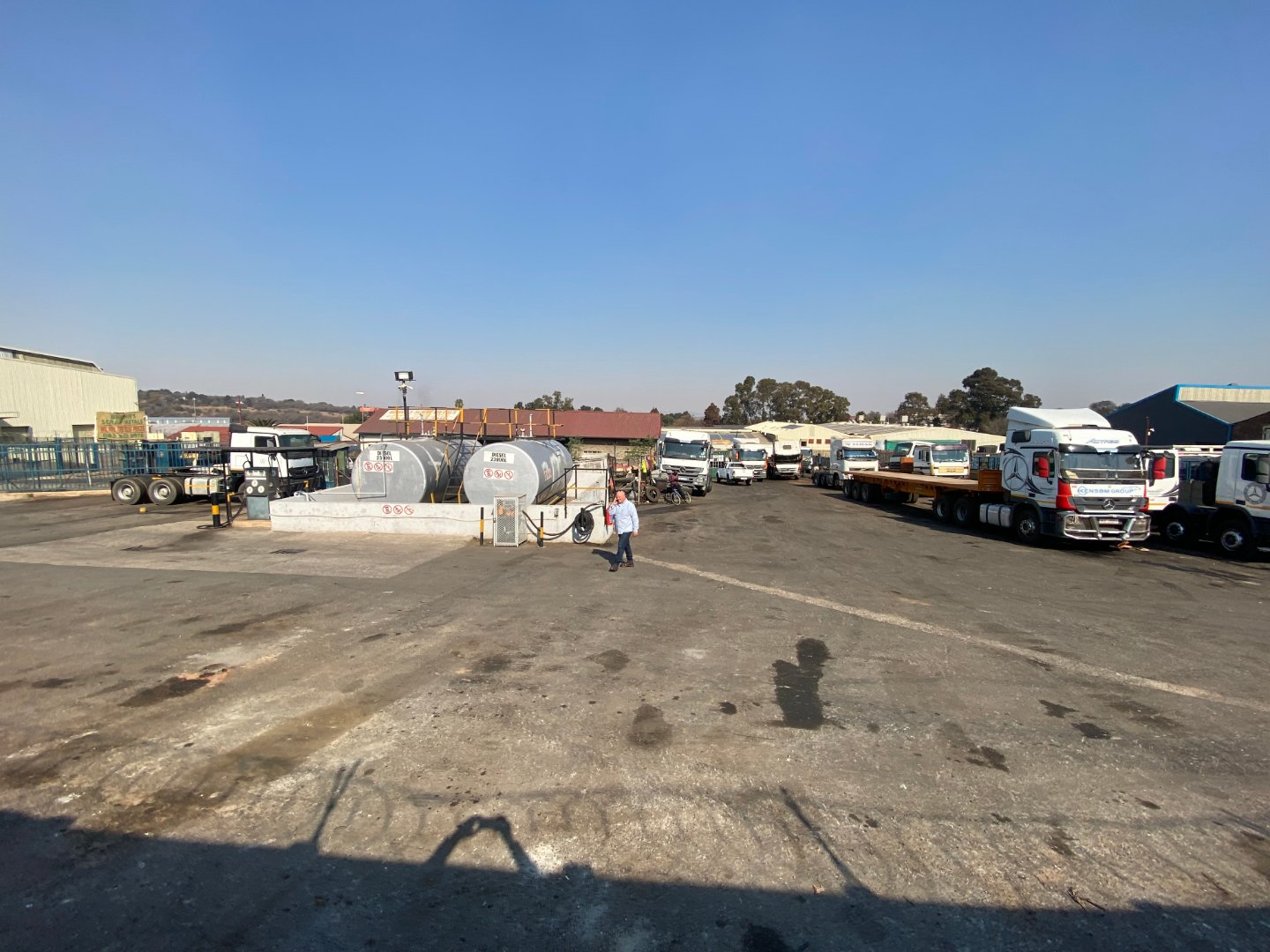 Large industrial property with trucks and warehouses in Alberton, South Africa, showcasing a spacious yard for logistics and storage.