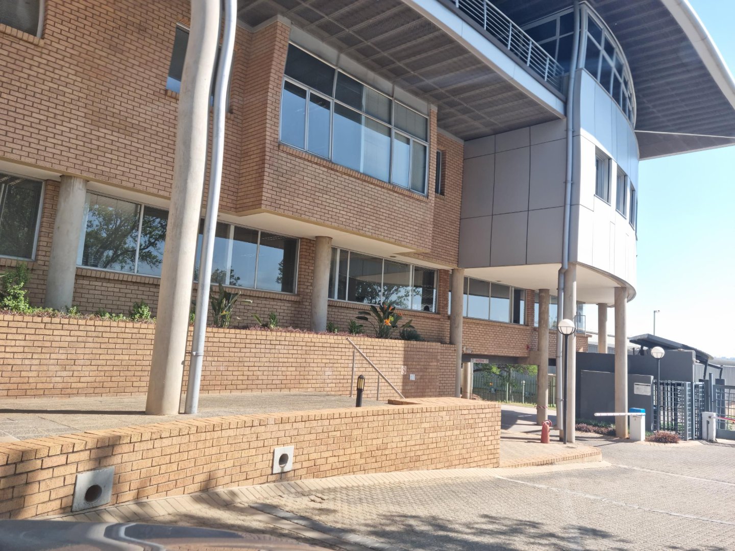 Modern office and warehouse building of Currie Group with brick and glass facade, located in South Africa, showcasing professional commercial architecture.