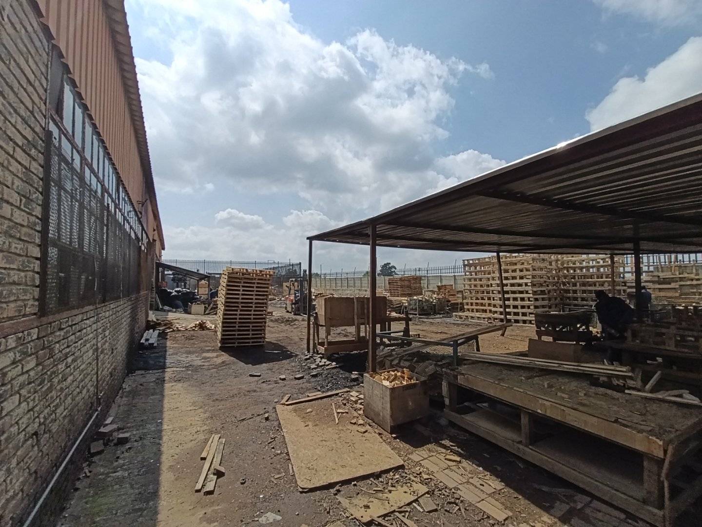 View of an industrial warehouse under construction in Alrode with building materials and equipment present, showcasing ongoing development.
