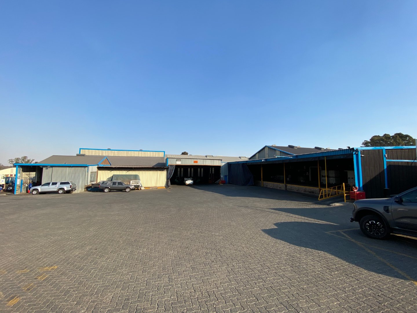 Large industrial warehouse with parking area in Alberton North, showcasing modern facilities and ample space for logistics and manufacturing operations.