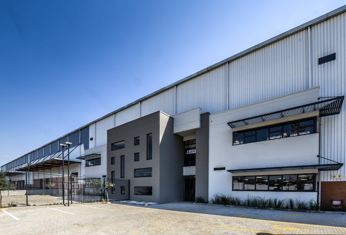 Contemporary office and warehouse building with sleek design, large windows, and spacious surroundings, representing Currie Group's modern infrastructure since 1887.