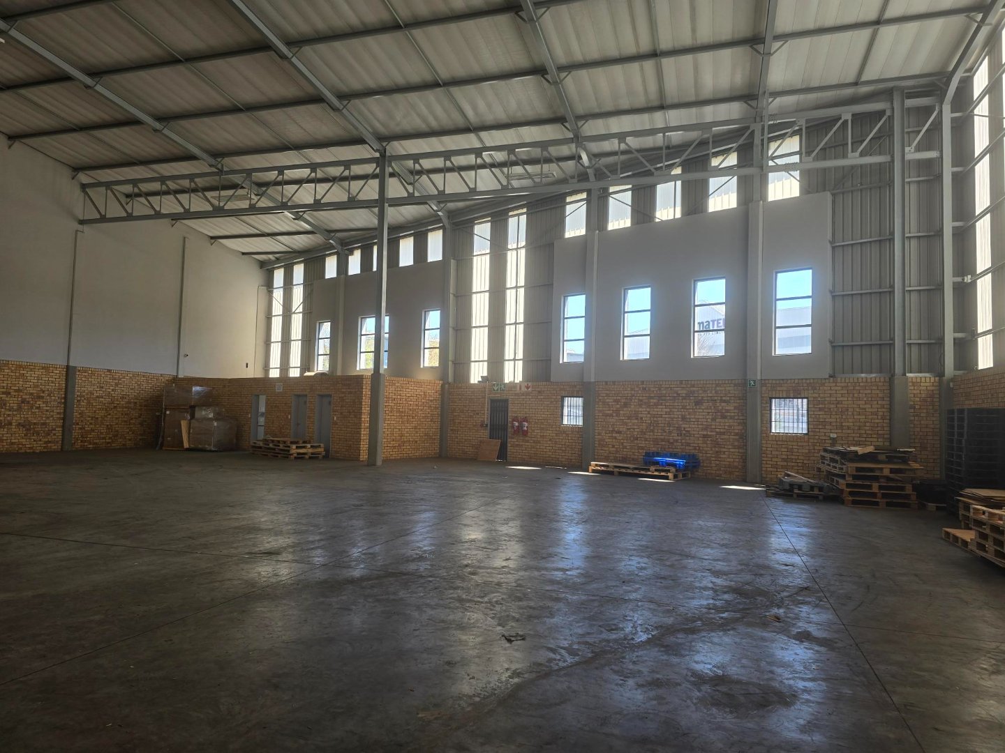 Large industrial warehouse with high ceilings, ample natural light, and open floor space in Linbro Park, suitable for storage or manufacturing.