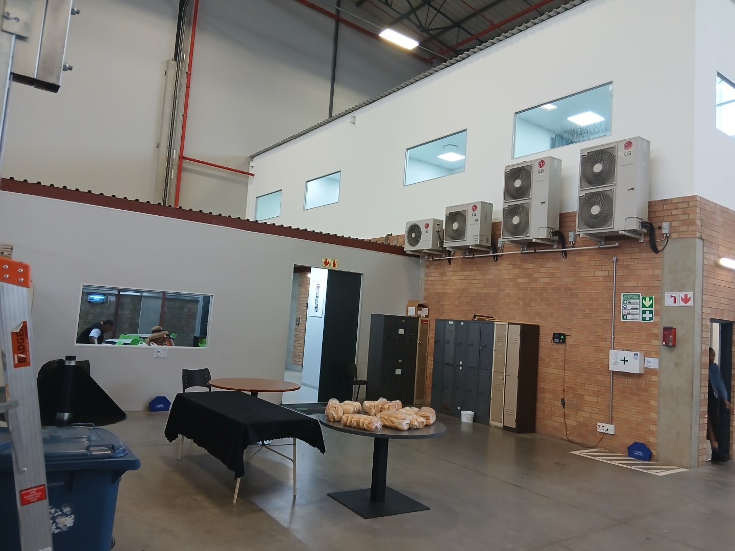 Modern office and warehouse space of Currie Group with air conditioning units and lockers, showcasing industrial and office environment.